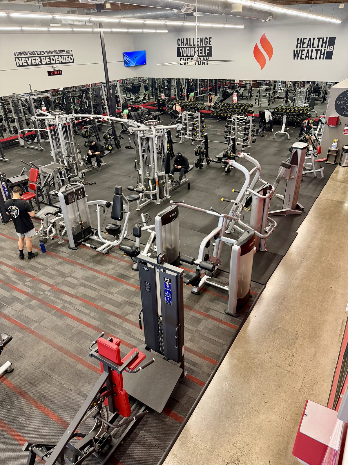 Mezzanine view over the main strength floor with the Never Be Denied wall